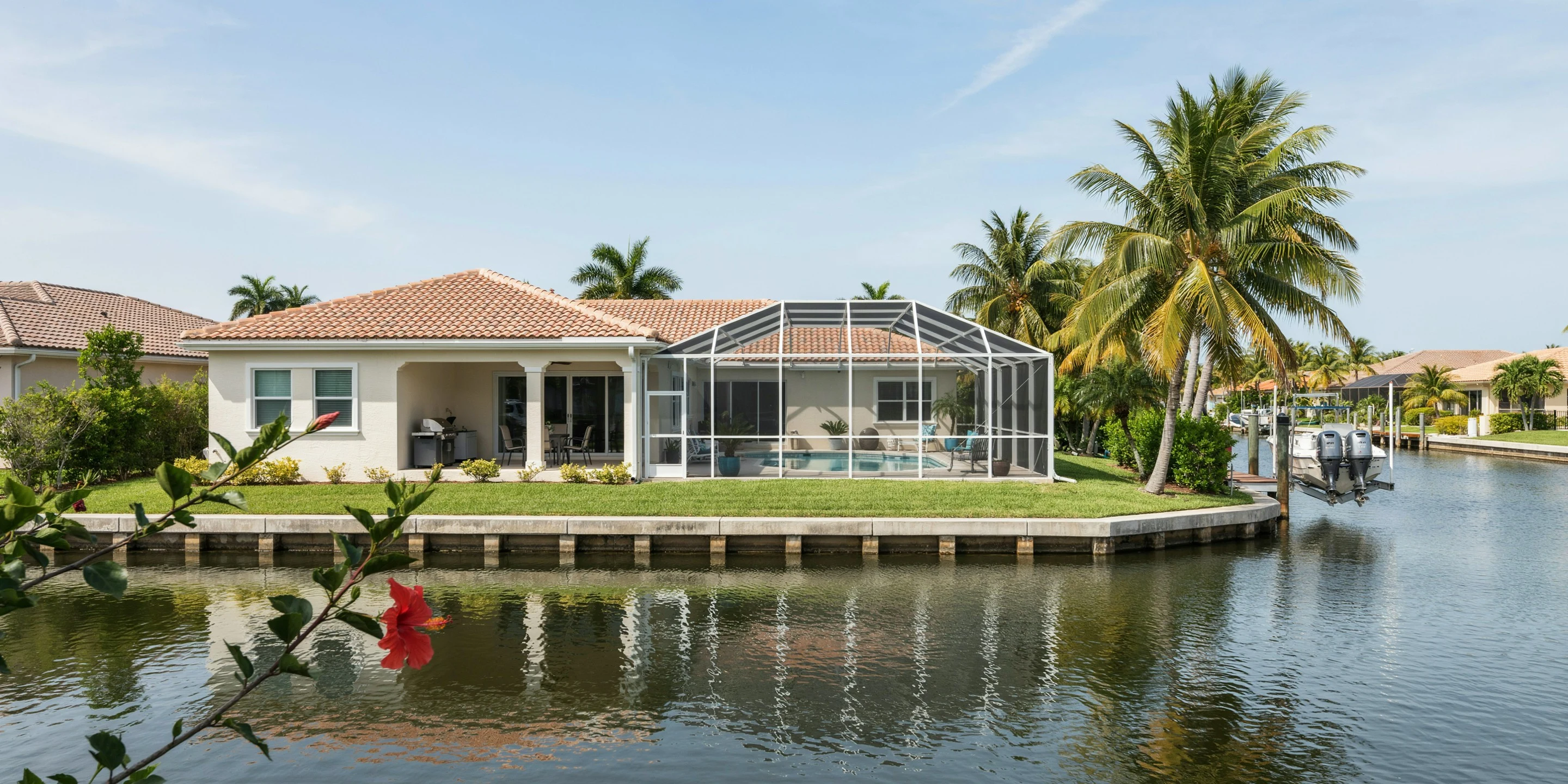Canal-front home with pool cage and dock in Palma Sola Park, Bradenton, FL