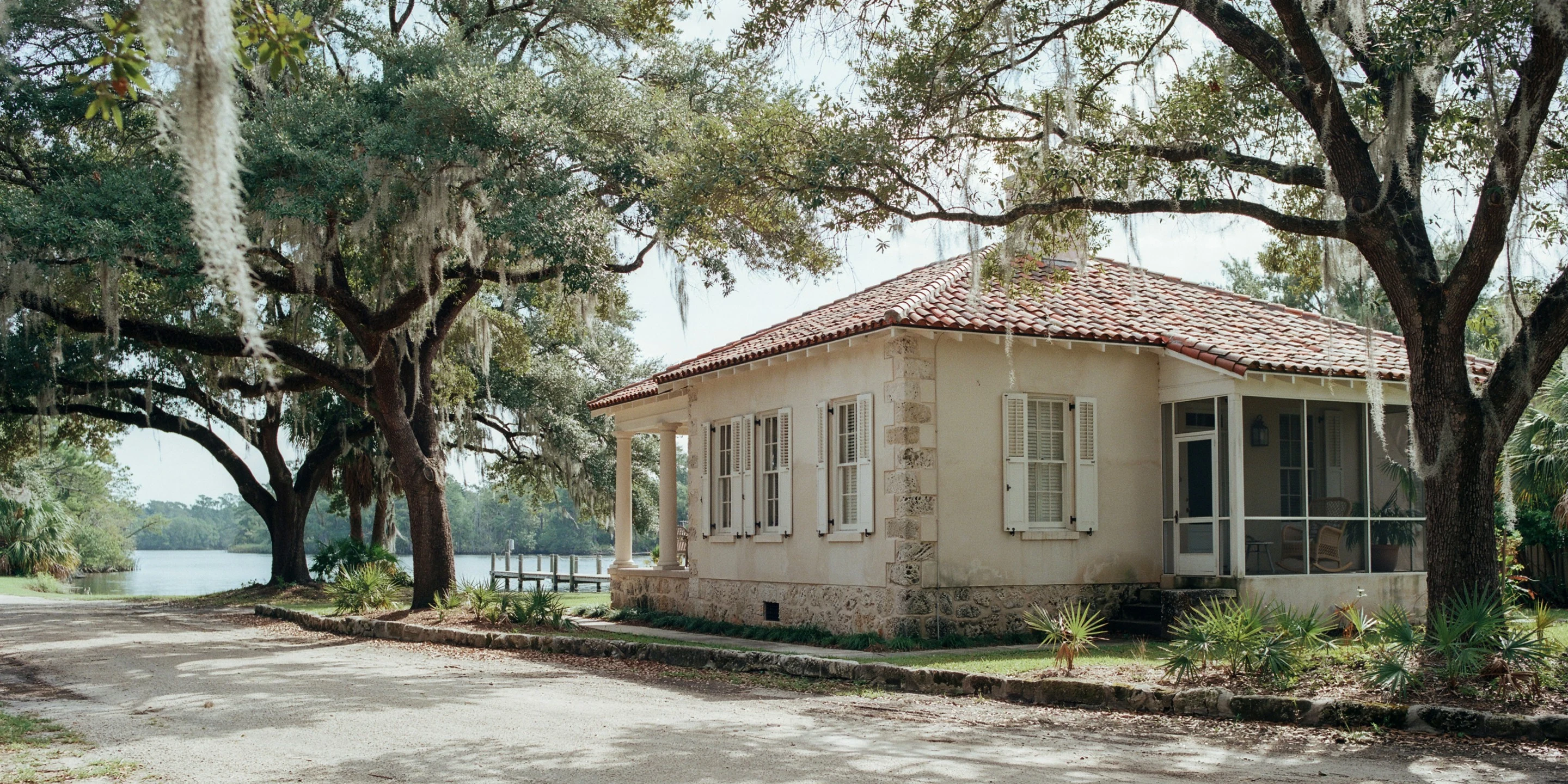 1930s stone riverfront home under live oaks on Riverview Boulevard, Bradenton, FL